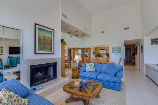 a living room with furniture ceiling fan and a fireplace