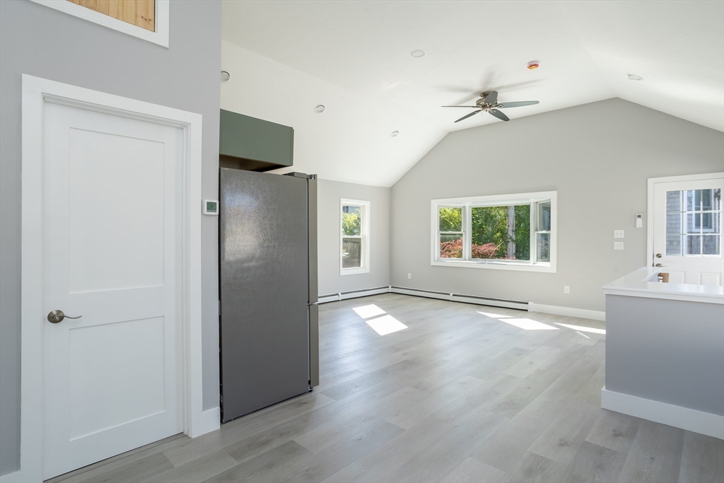 3 A Thompson Road, Unit A Bourne, MA 02532 - Photo 14 of 42 a view of an empty room with a window and wooden floor