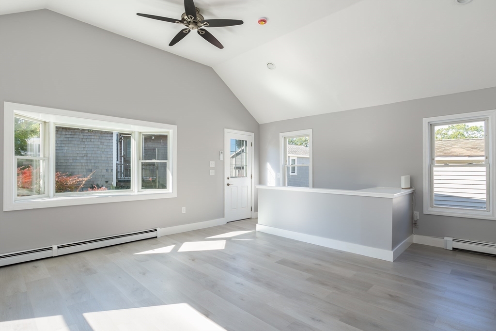 3 A Thompson Road, Unit A Bourne, MA 02532 - Photo 15 of 42 an empty room with wooden floor and windows