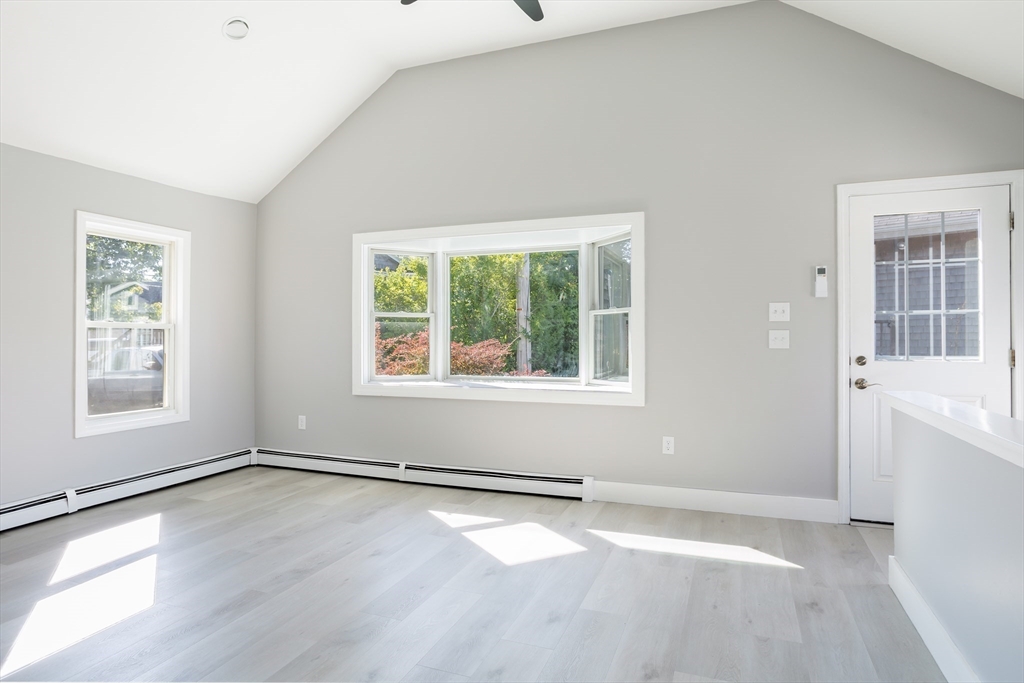 3 A Thompson Road, Unit A Bourne, MA 02532 - Photo 16 of 42 an empty room with wooden floor and windows