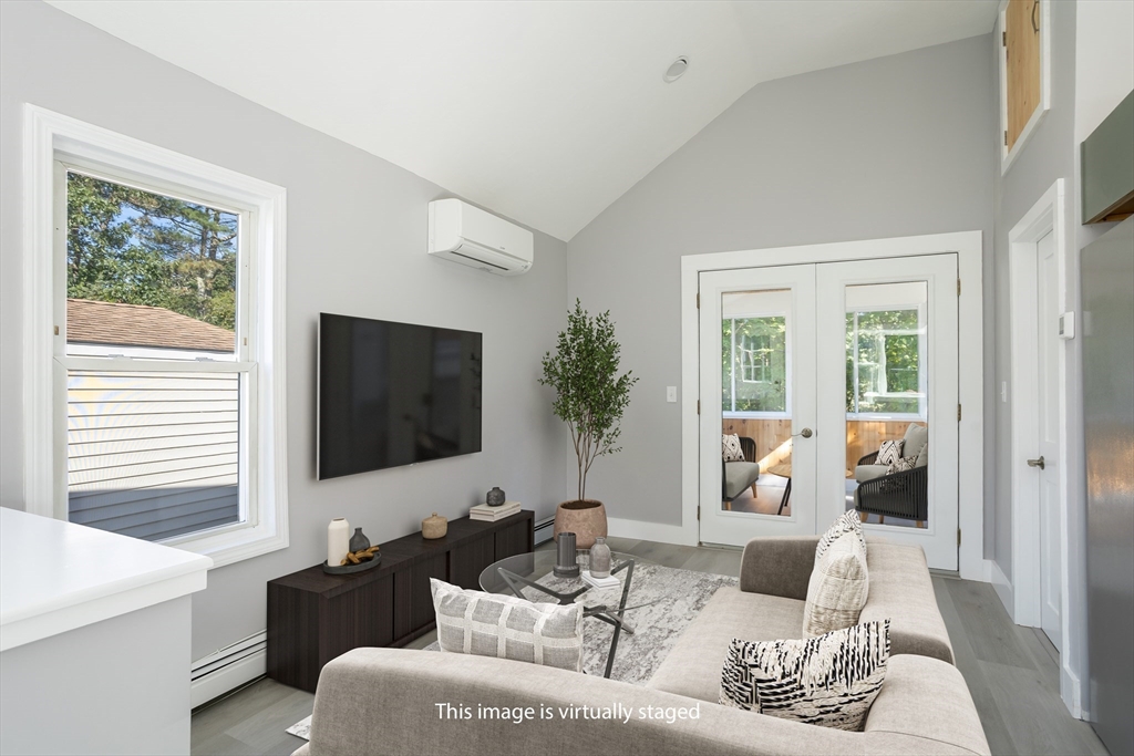 3 A Thompson Road, Unit A Bourne, MA 02532 - Photo 19 of 42 a living room with furniture and a flat screen tv