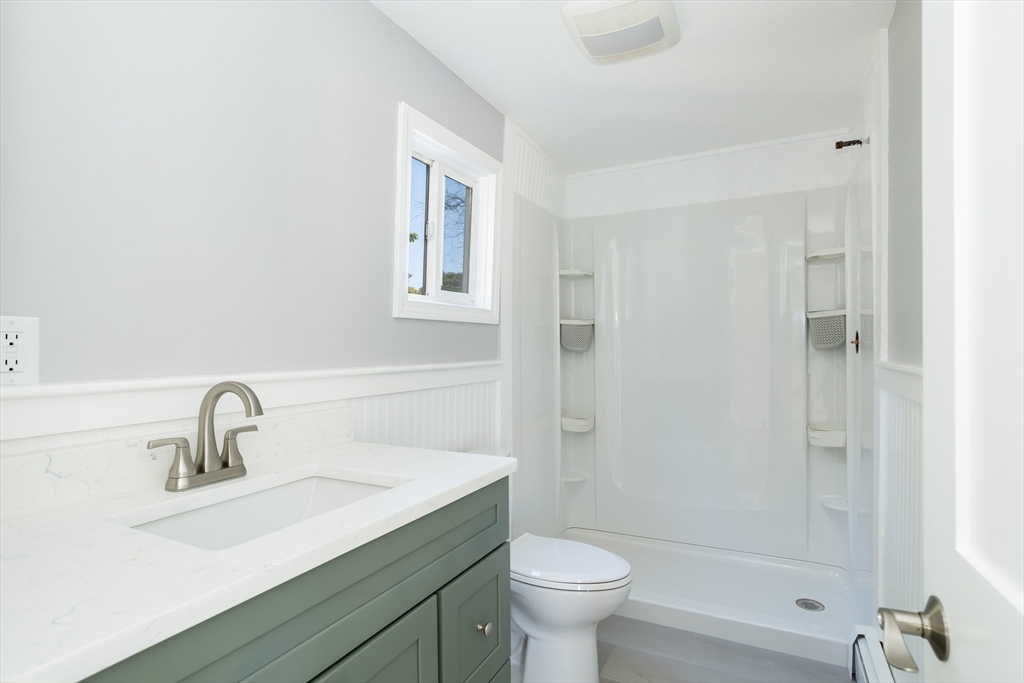 3 A Thompson Road, Unit A Bourne, MA 02532 - Photo 20 of 42 a bathroom with a sink toilet a mirror and shower