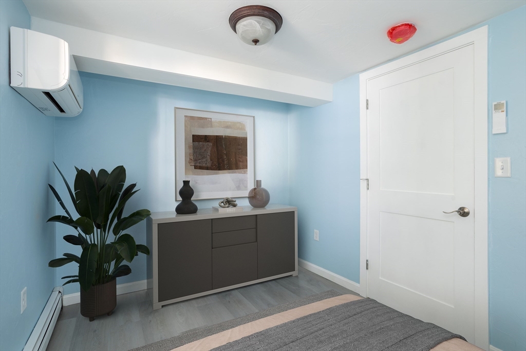 3 A Thompson Road, Unit A Bourne, MA 02532 - Photo 31 of 42 a living room with furniture and a potted plant