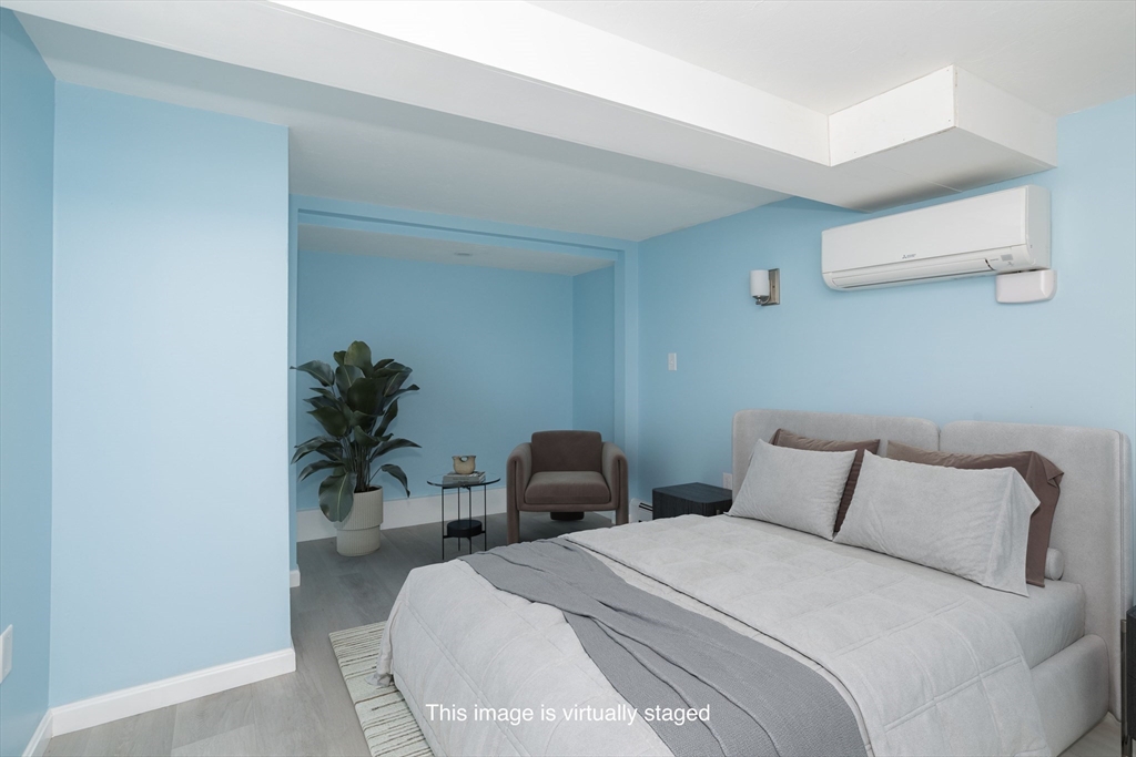 3 A Thompson Road, Unit A Bourne, MA 02532 - Photo 34 of 42 a bedroom with a bed and a potted plant