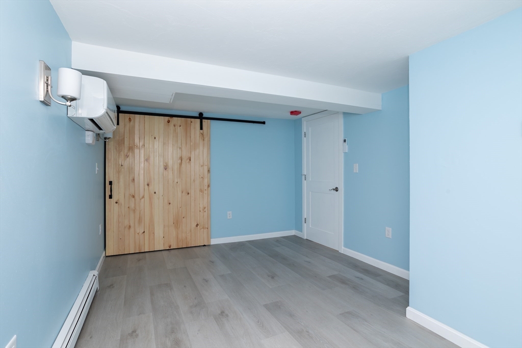 3 A Thompson Road, Unit A Bourne, MA 02532 - Photo 36 of 42 an empty room with wooden floor mirror and entrance