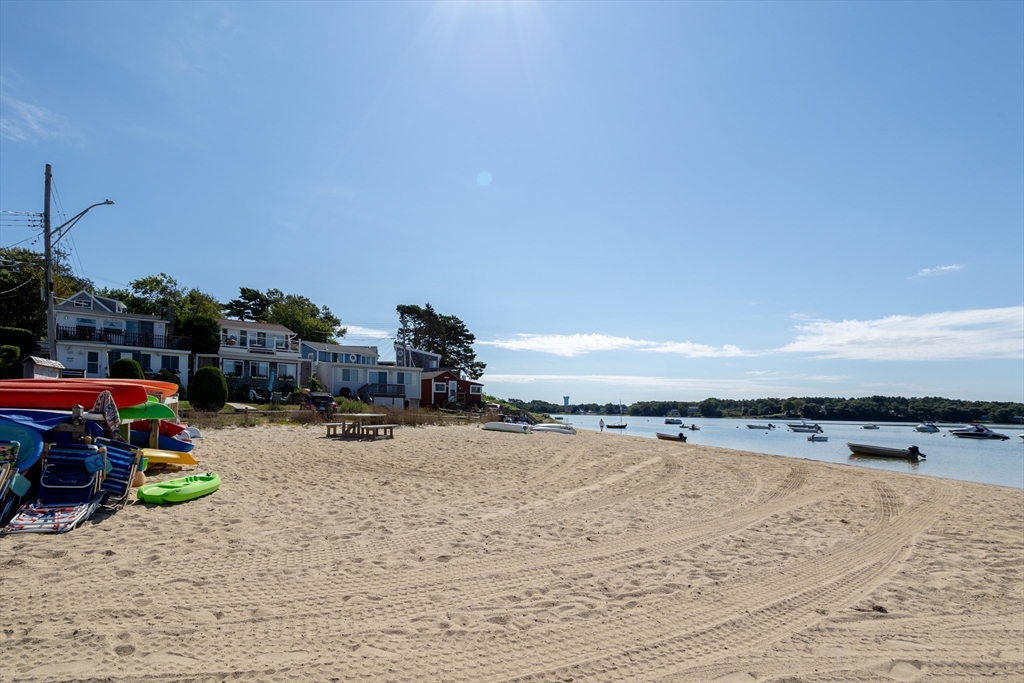 3 A Thompson Road, Unit A Bourne, MA 02532 - Photo 40 of 42 a view of a lake with and car parked