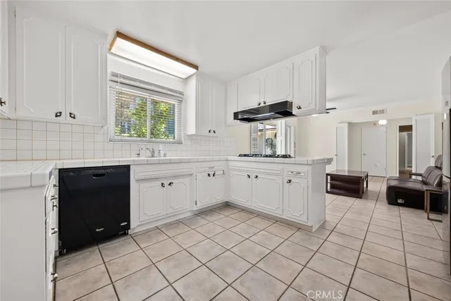 a kitchen with a sink cabinets and window