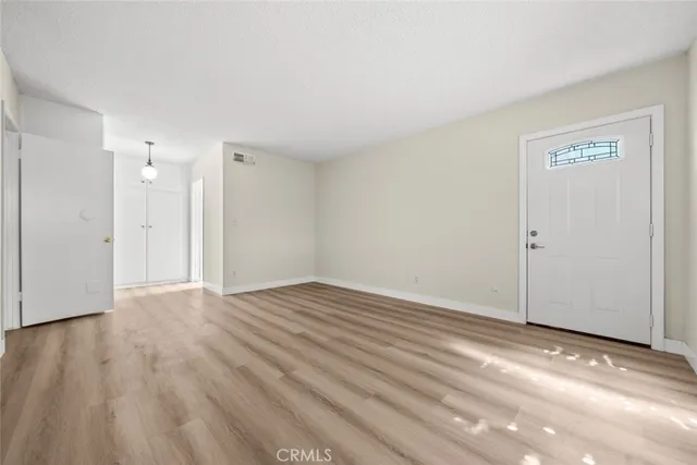 a view of an empty room and wooden floor