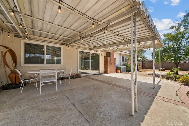 a outdoor space with lots of tables a chair and glass door