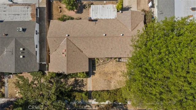 an aerial view of a house with a yard