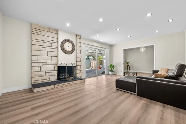 a living room with fireplace furniture and a wooden floor