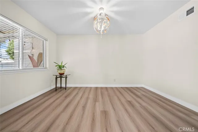 a view of room with window and wooden floor