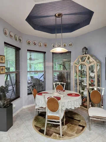 a dining room with furniture a chandelier and window