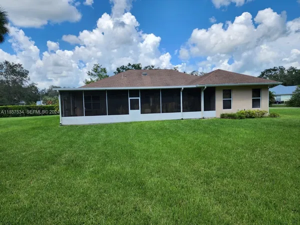a view of a house with a backyard