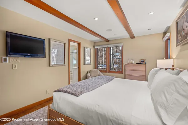 a bedroom with a large bed and a window