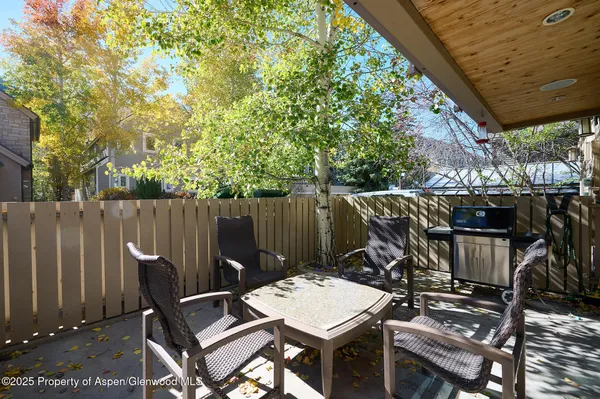 a view of a chairs and table in the patio