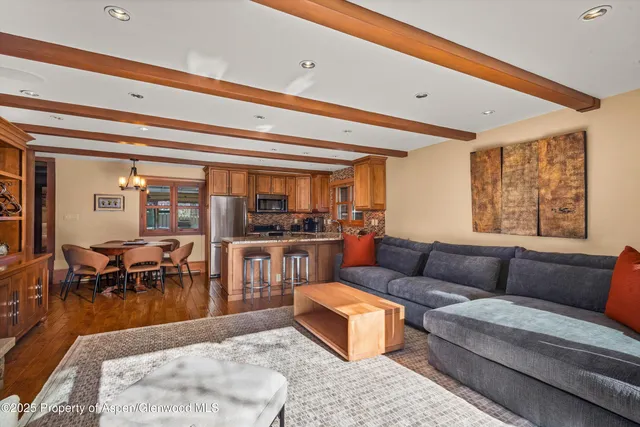 a living room with stainless steel appliances granite countertop furniture and a kitchen view
