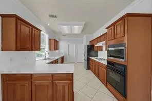 a kitchen with stainless steel appliances a refrigerator and a sink