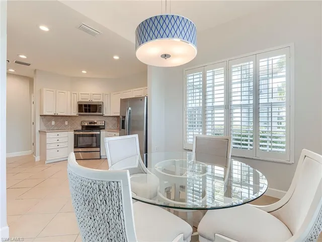 a kitchen with furniture and a chandelier
