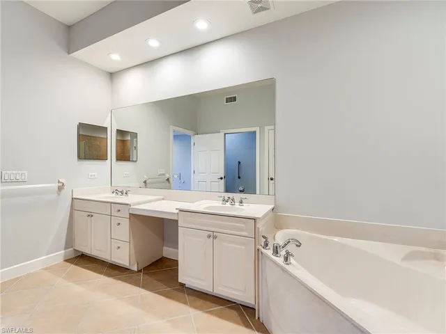 a bathroom with a bathtub and a sink