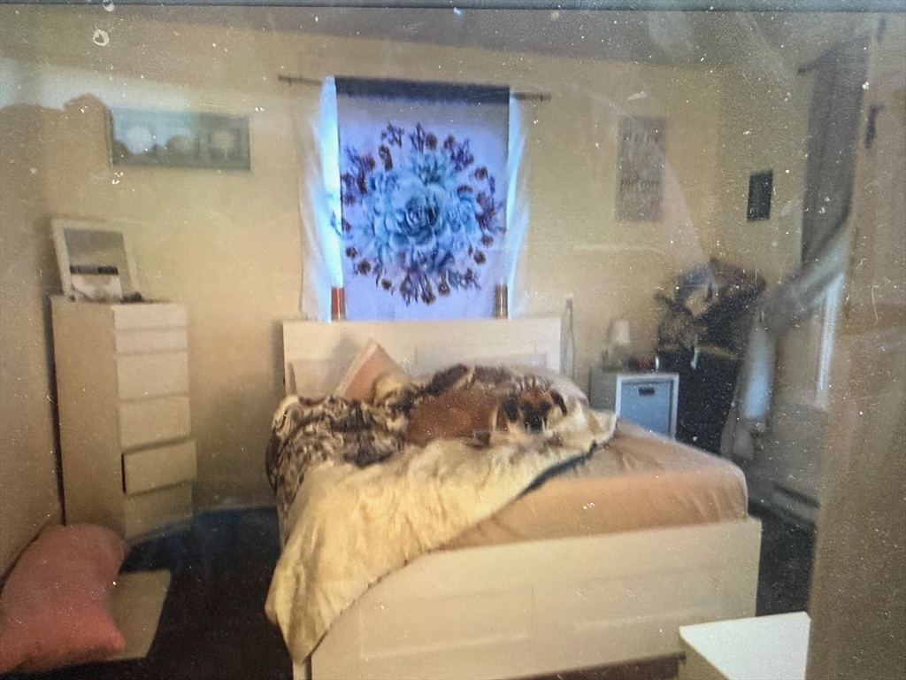 73 Kinsley Street, Unit B Nashua, NH 03060 - Photo 3 of 4 a bedroom with a bed and a painting on the wall