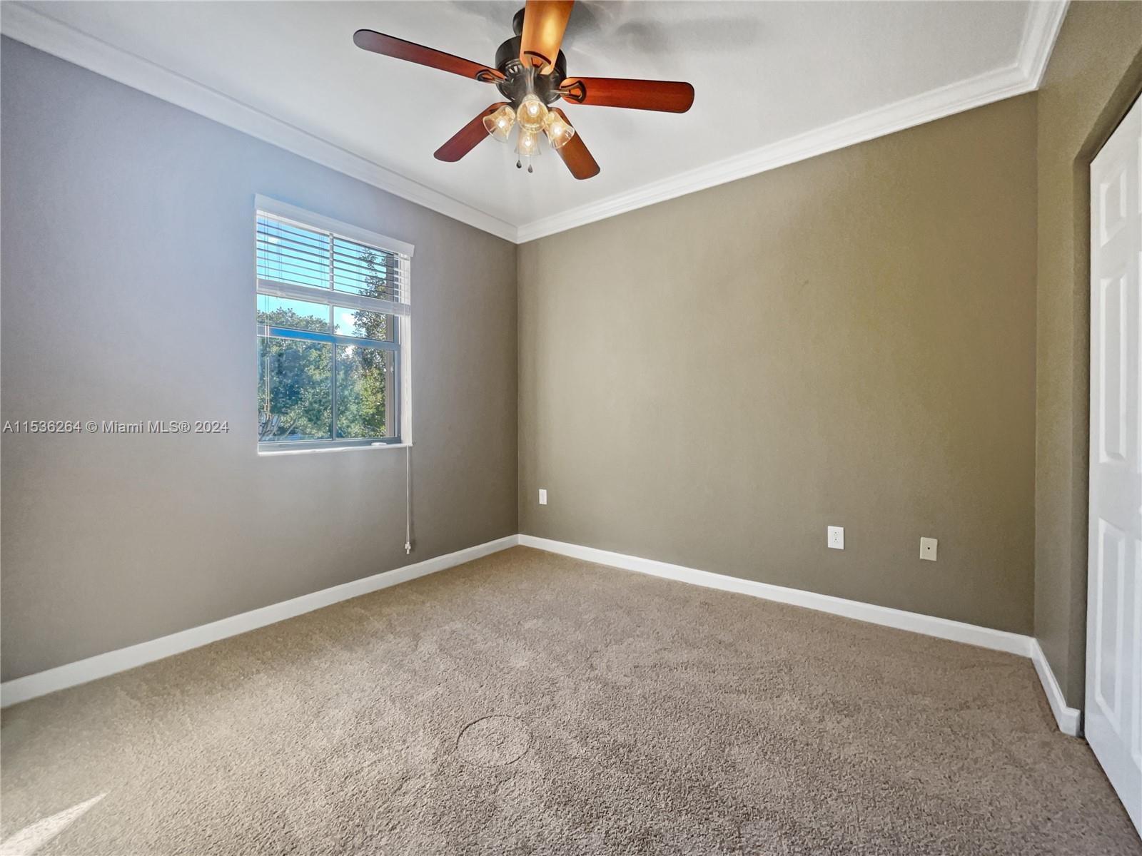 11351 Southwest 240th Street, Unit 1 Homestead, FL 33032 - Photo 14 of 24 an empty room with windows and fan