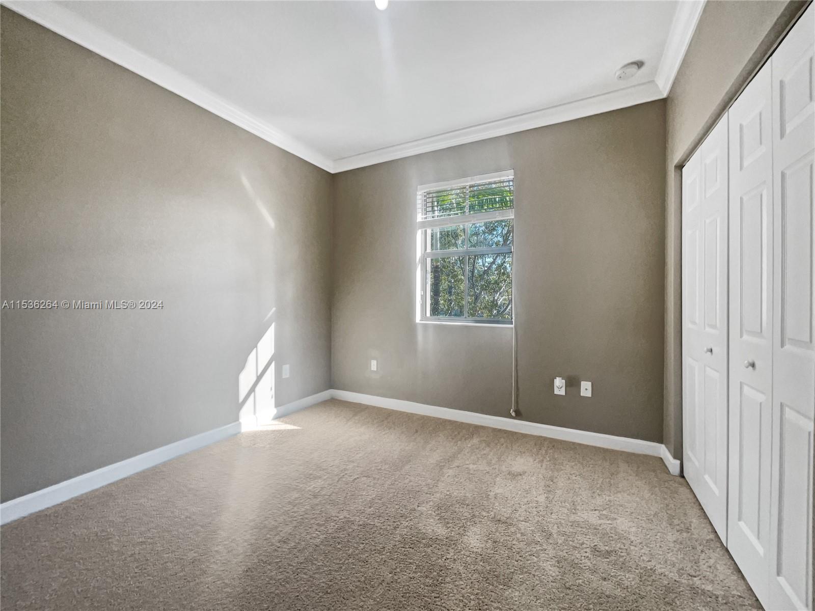 11351 Southwest 240th Street, Unit 1 Homestead, FL 33032 - Photo 15 of 24 a view of an empty room with a window