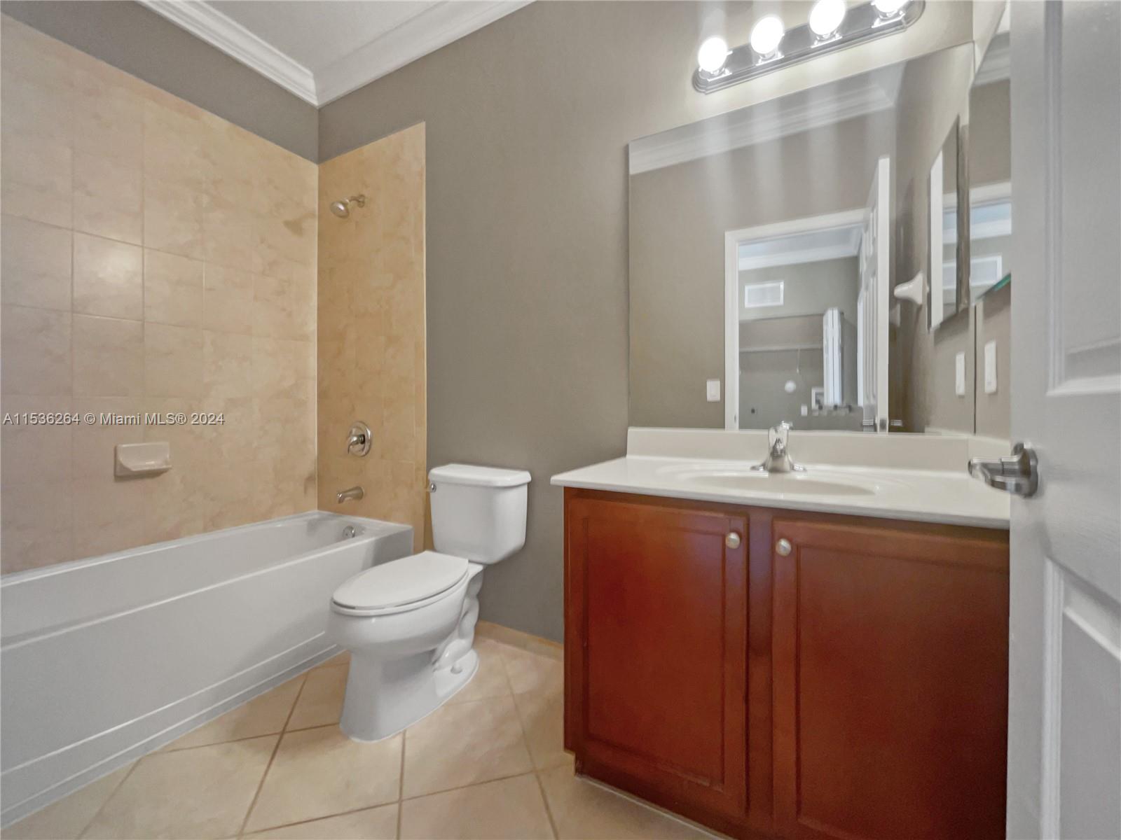 11351 Southwest 240th Street, Unit 1 Homestead, FL 33032 - Photo 16 of 24 a bathroom with a sink toilet and shower