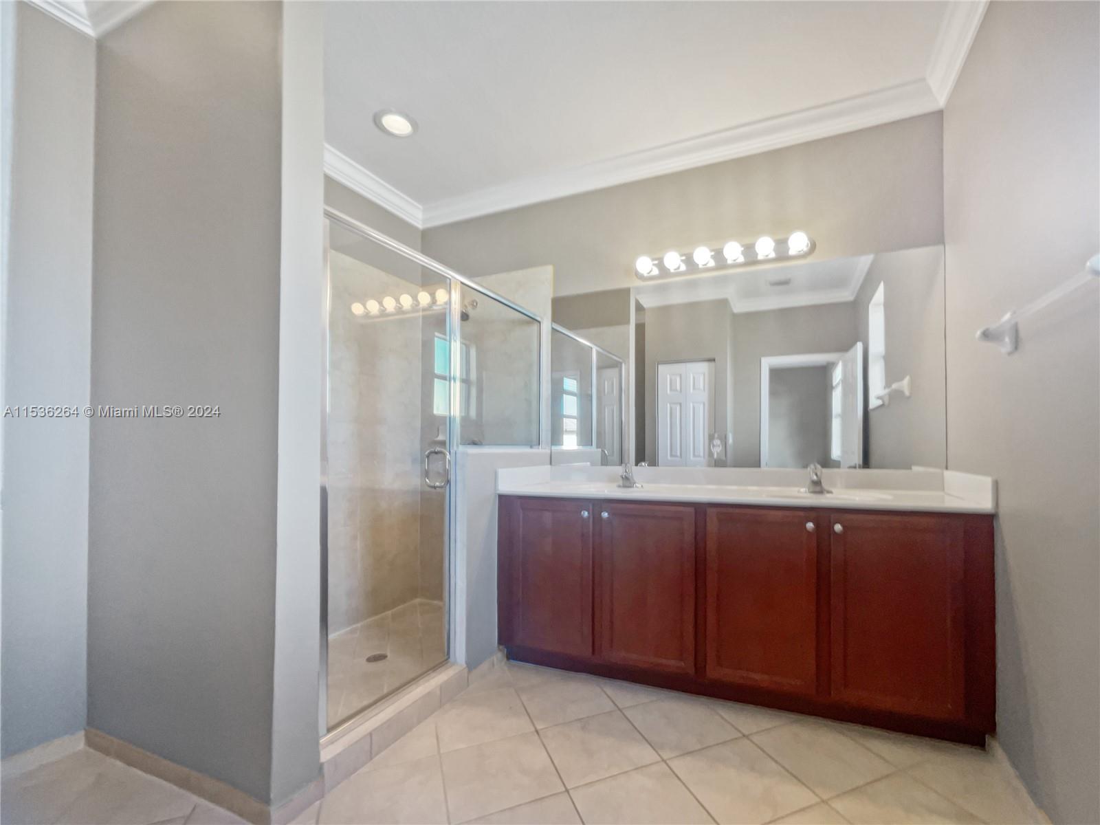11351 Southwest 240th Street, Unit 1 Homestead, FL 33032 - Photo 18 of 24 a bathroom with a double vanity sink and mirror