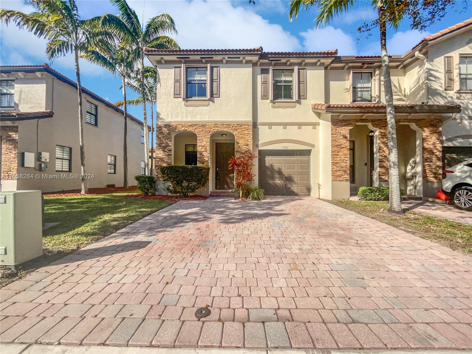 11351 Southwest 240th Street, Unit 1 Homestead, FL 33032 - Photo 20 of 24 a view of a house with a yard