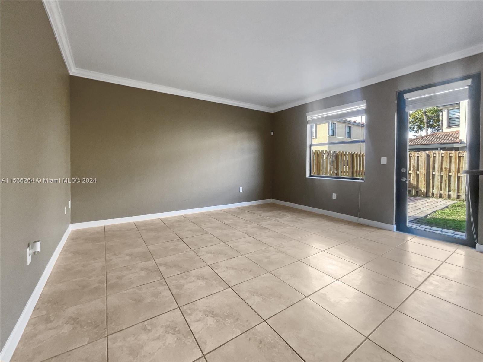 11351 Southwest 240th Street, Unit 1 Homestead, FL 33032 - Photo 2 of 24 a view of an empty room with a window