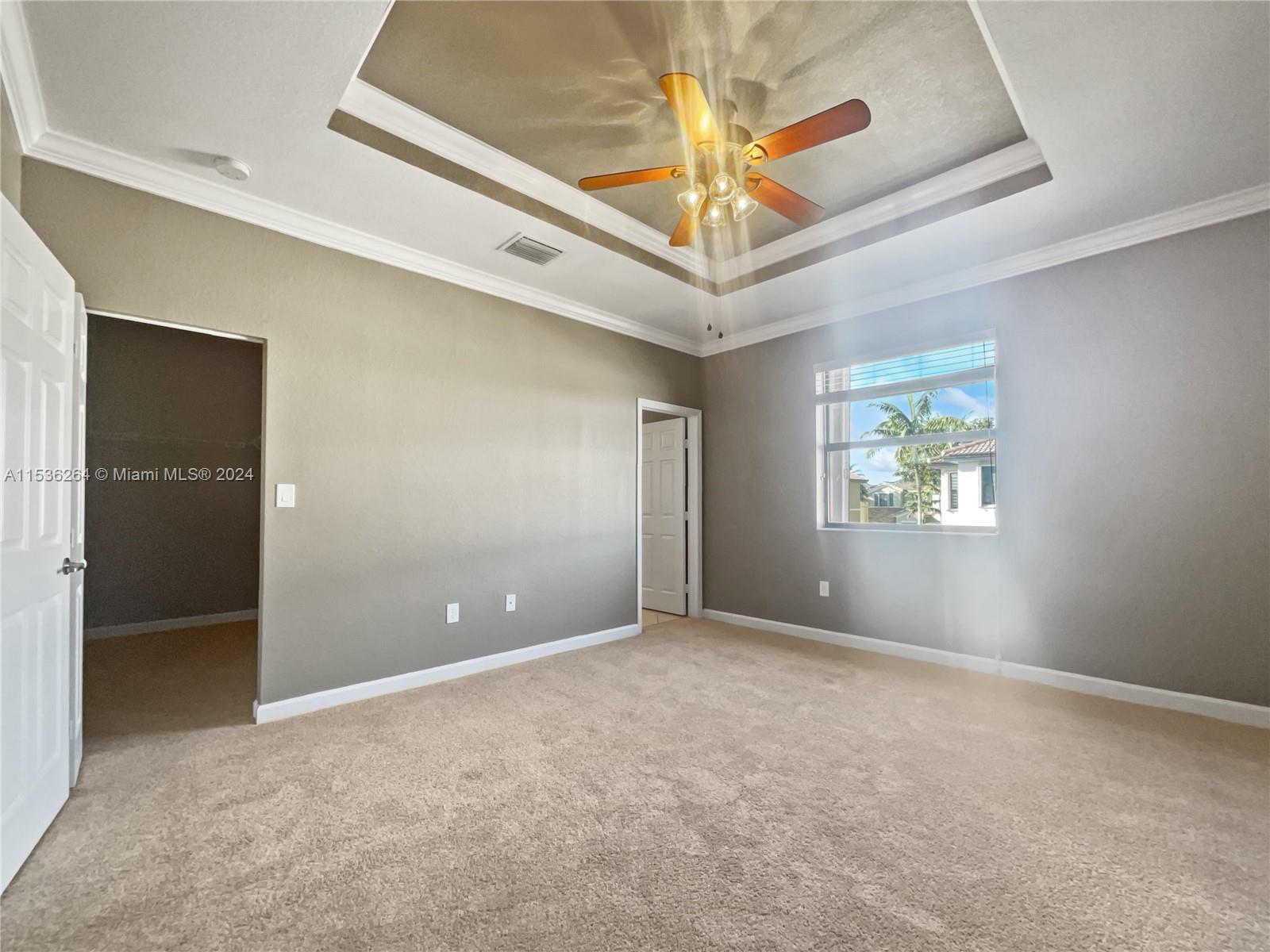 11351 Southwest 240th Street, Unit 1 Homestead, FL 33032 - Photo 3 of 24 an empty room with windows and fan