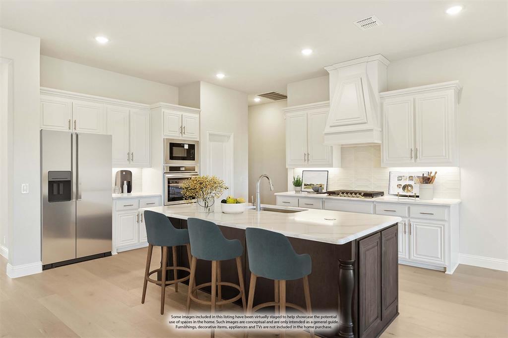 1024 Silver Sage Drive Justin, TX 76247 - Photo 16 of 35 a kitchen with stainless steel appliances granite countertop a table chairs sink refrigerator and microwave