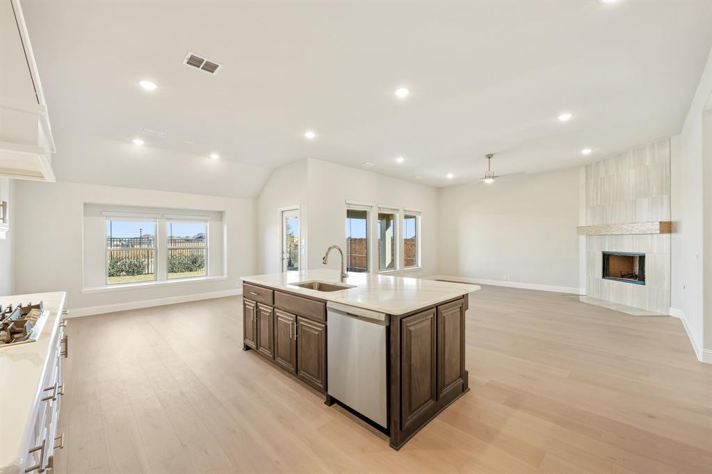 1024 Silver Sage Drive Justin, TX 76247 - Photo 21 of 35 a kitchen with a sink and a stove top oven