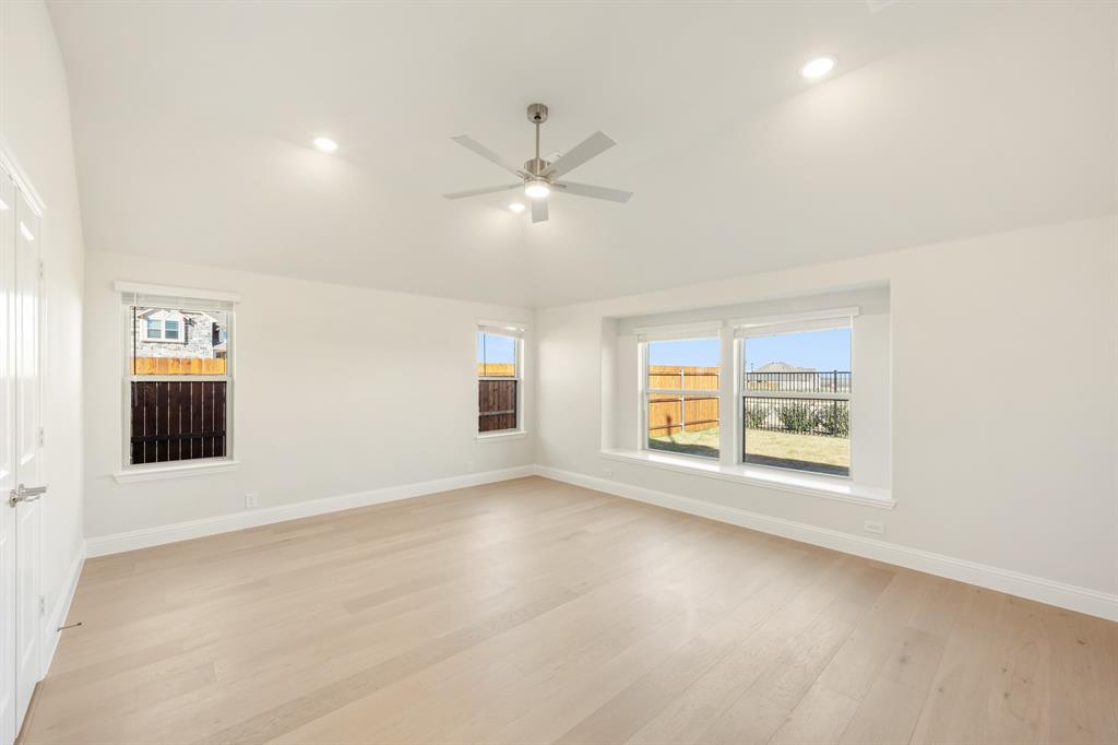 1024 Silver Sage Drive Justin, TX 76247 - Photo 22 of 35 an empty room with windows and ceiling fan