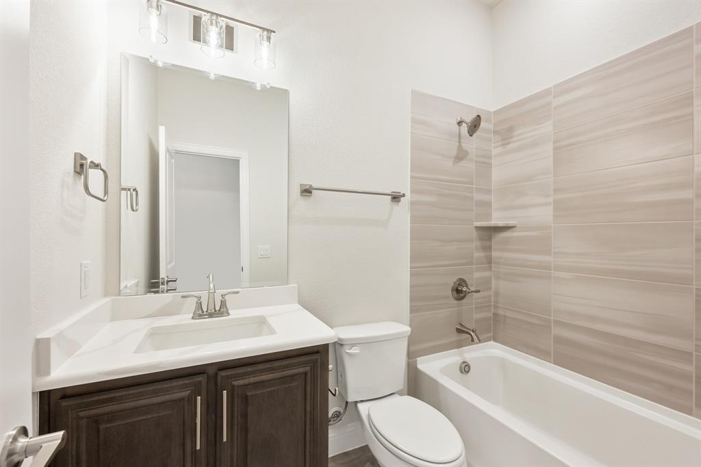 1024 Silver Sage Drive Justin, TX 76247 - Photo 28 of 35 a bathroom with a granite countertop sink toilet and shower
