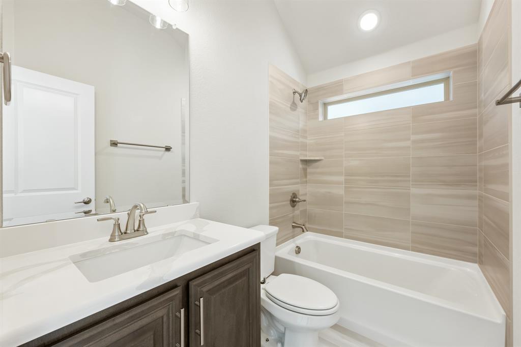 1024 Silver Sage Drive Justin, TX 76247 - Photo 30 of 35 a bathroom with a sink a toilet and shower
