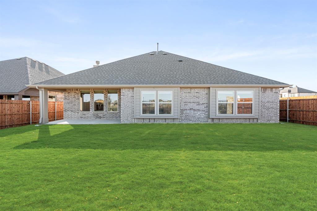 1024 Silver Sage Drive Justin, TX 76247 - Photo 34 of 35 a front view of a house with a garden