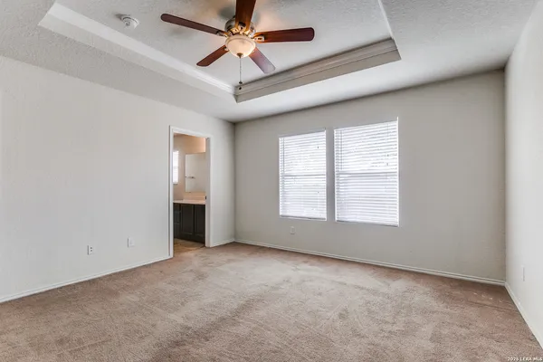 a bathroom with a granite countertop sink a toilet and a mirror