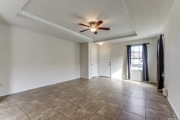 a view of a livingroom with a ceiling fan and window