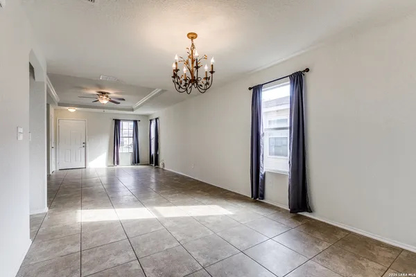 a view of empty room with a ceiling fan and window