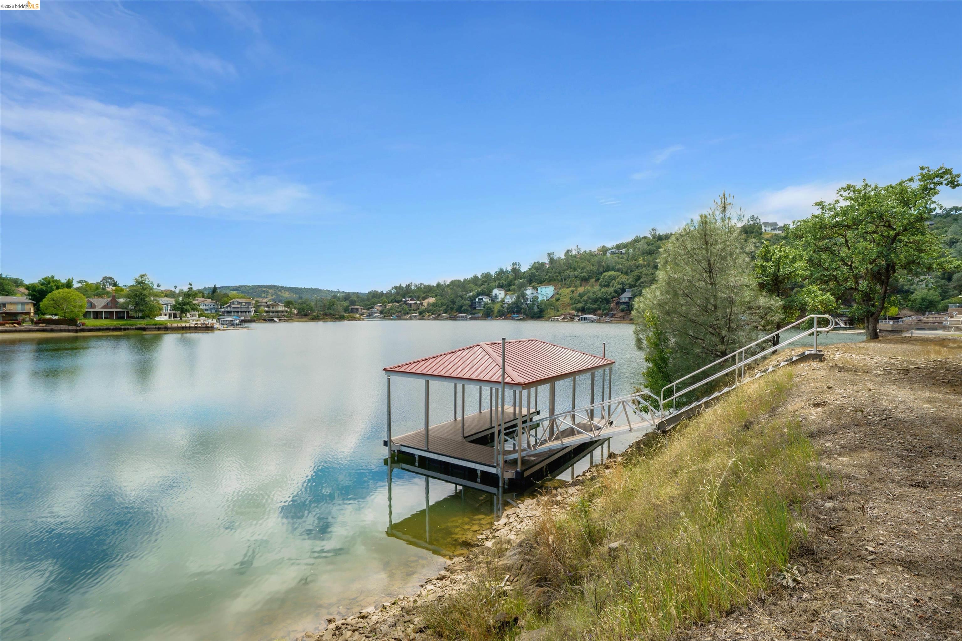 4459 Council Trail Copperopolis, CA 95228 - Photo 2 of 16 a view of a swimming pool with a lake view