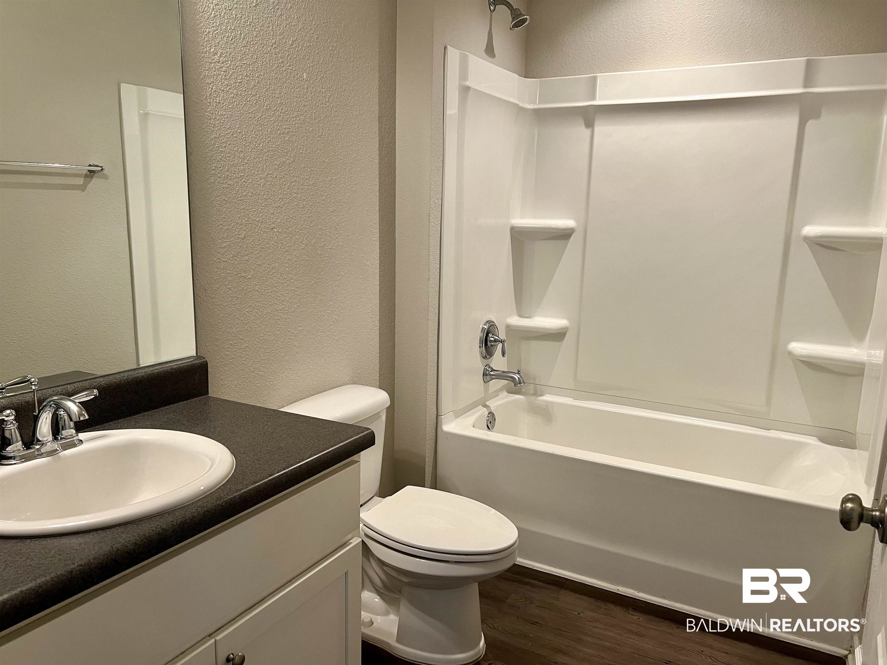 1612 Abbey Loop Foley, AL 36535 - Photo 25 of 30 Full bathroom featuring shower / bathing tub combination, vanity, toilet, and hardwood / wood-style flooring