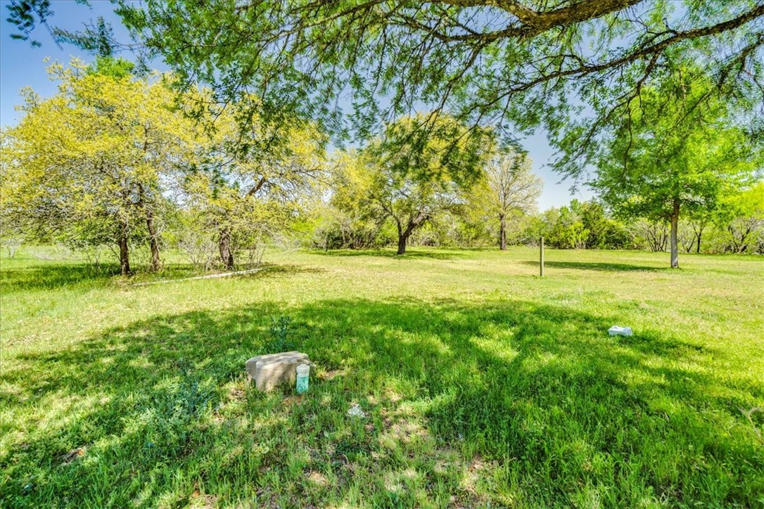 497 Mt Pleasant Road, Unit A Cedar Creek, TX 78612 - Photo 5 of 21 a view of outdoor space with deck and yard