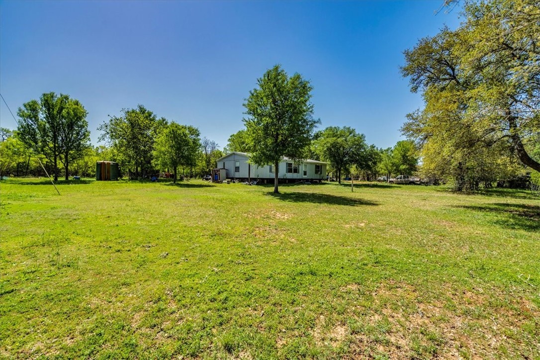 497 Mt Pleasant Road, Unit A Cedar Creek, TX 78612 - Photo 6 of 21 a view of a swimming pool and trees in the background