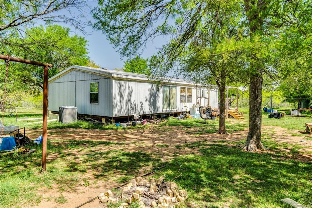497 Mt Pleasant Road, Unit A Cedar Creek, TX 78612 - Photo 8 of 21 a view of a house with a yard