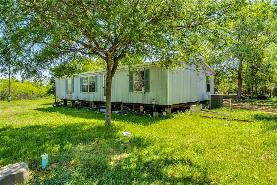 497 Mt Pleasant Road, Unit A Cedar Creek, TX 78612 - Photo 9 of 21 a view of a backyard with large trees