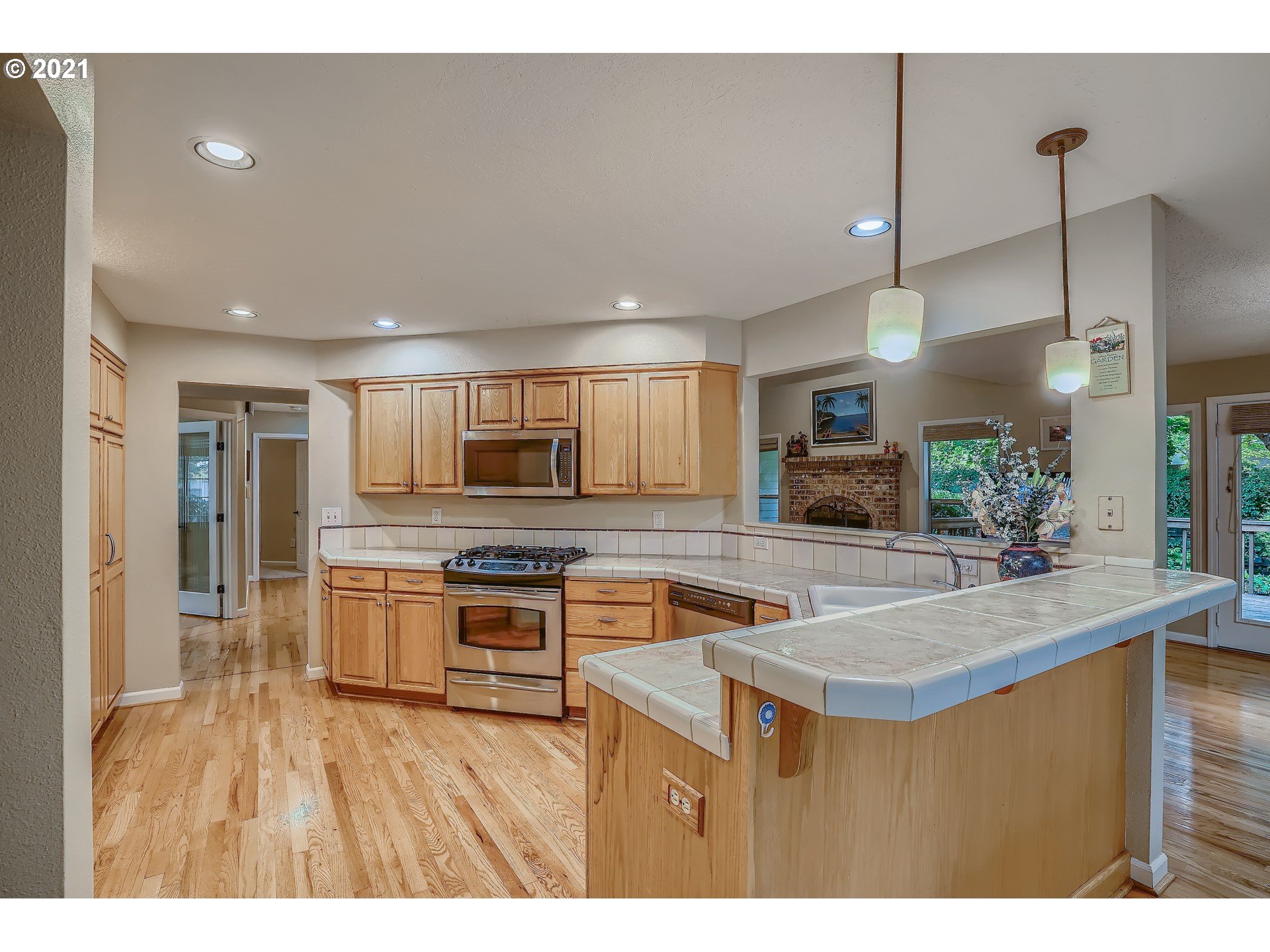 545 Southwest 167th Avenue Beaverton, OR 97006 - Photo 11 of 32 a kitchen with stainless steel appliances granite countertop a sink a stove and a refrigerator