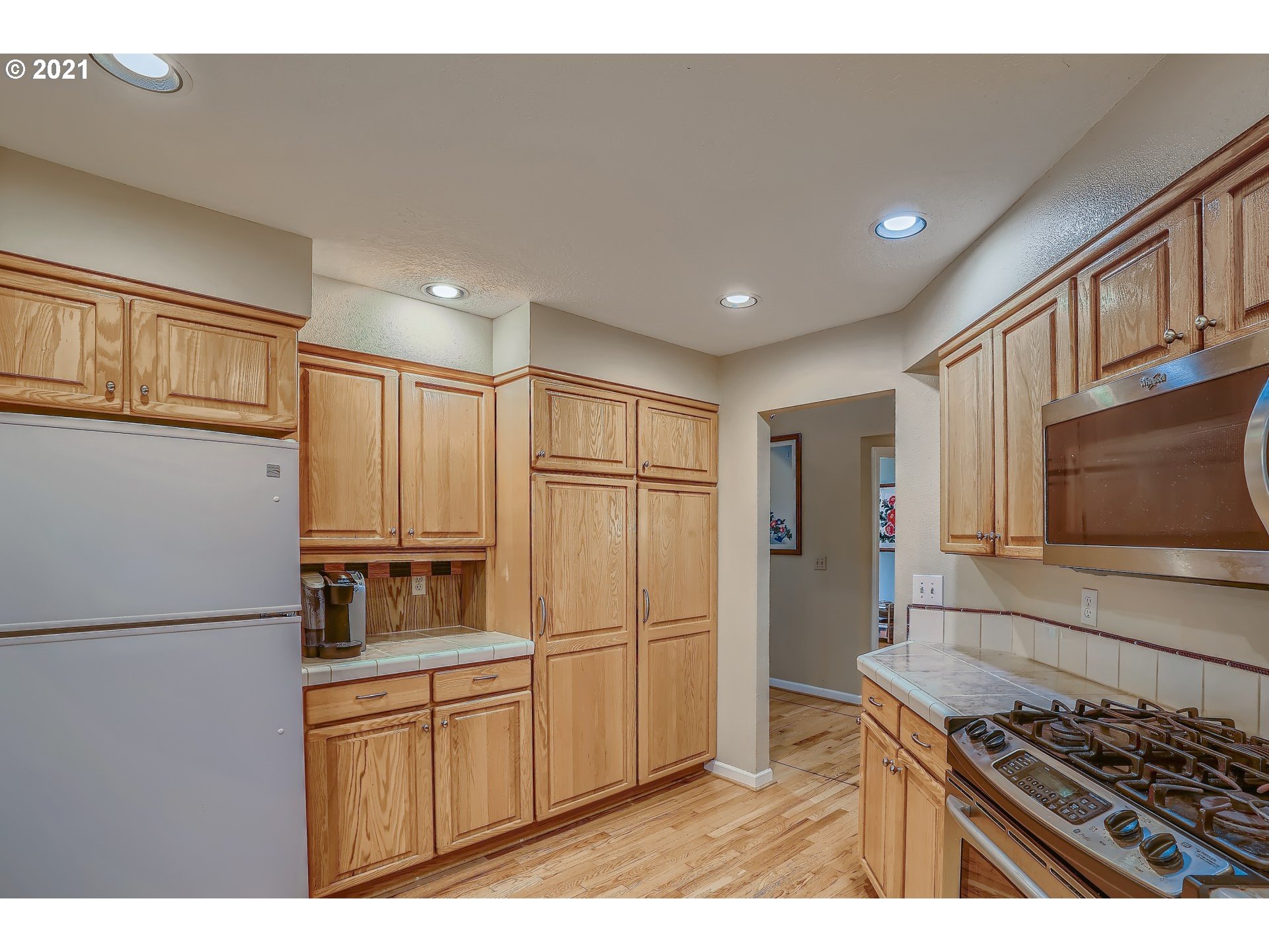 545 Southwest 167th Avenue Beaverton, OR 97006 - Photo 12 of 32 a kitchen with stainless steel appliances granite countertop a refrigerator a stove and a sink