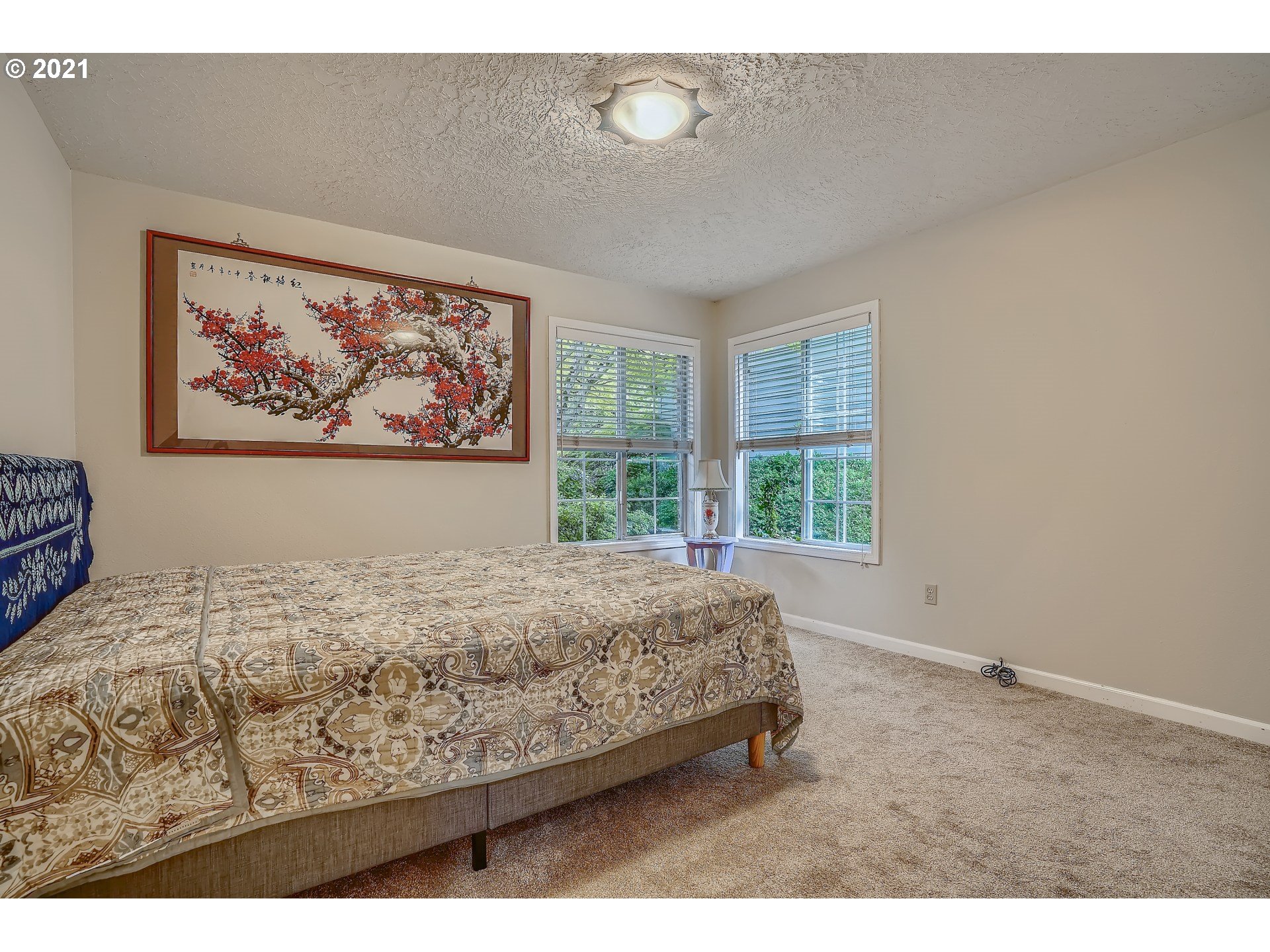 545 Southwest 167th Avenue Beaverton, OR 97006 - Photo 18 of 32 a bed sitting in a bedroom next to a window